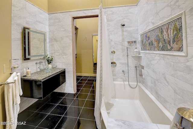 bathroom featuring tile patterned flooring, vanity, tiled shower, and tile walls