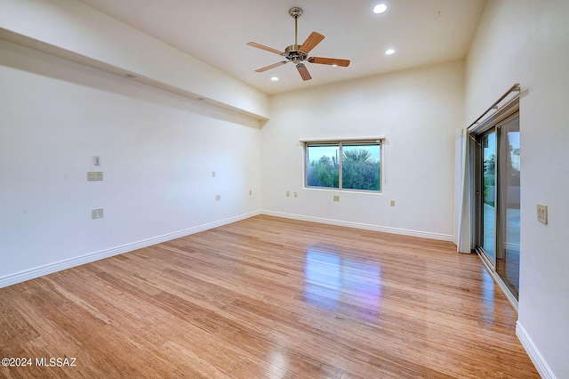 spare room with ceiling fan and light wood-type flooring