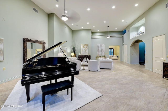 miscellaneous room with a towering ceiling