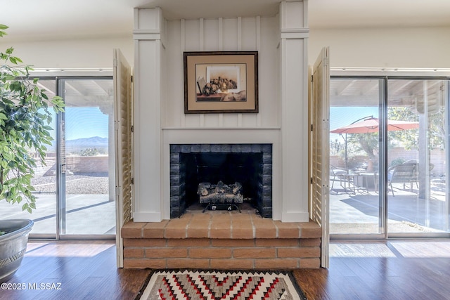 living room with dark wood-style floors and a fireplace