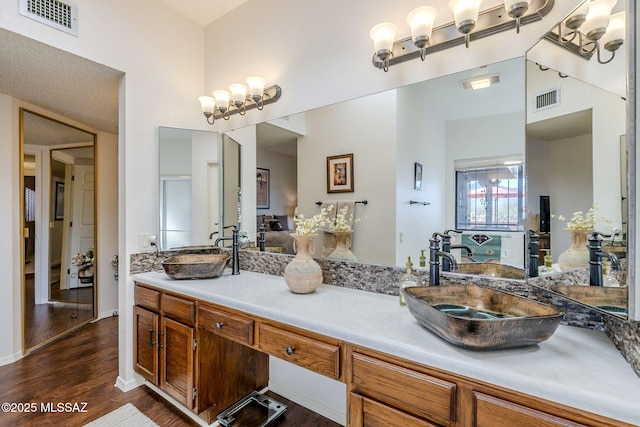 bathroom with vanity, wood finished floors, and visible vents