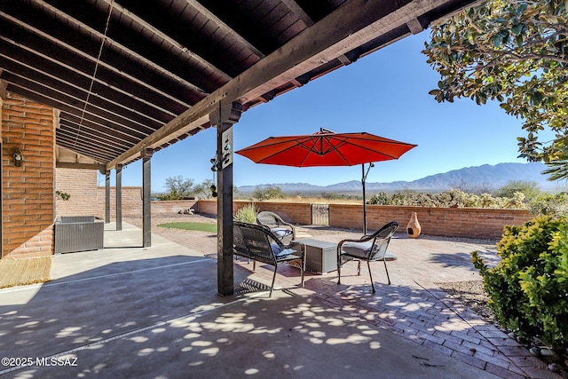 view of patio featuring a fenced backyard and a mountain view