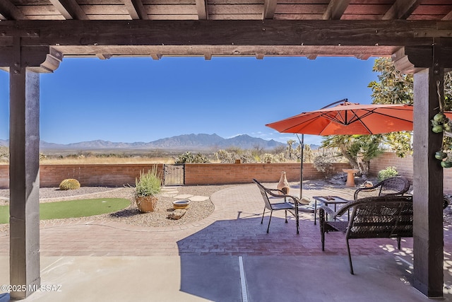 view of patio / terrace featuring a fenced backyard and a mountain view