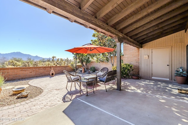 view of patio with a fenced backyard and a mountain view