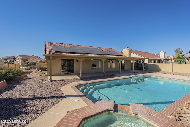 view of pool with cooling unit, an in ground hot tub, and a patio