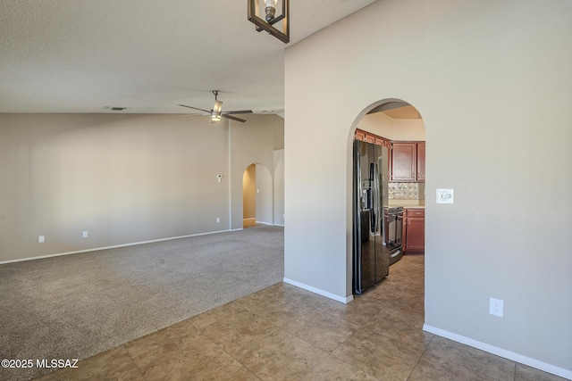 unfurnished room with light carpet, ceiling fan, and high vaulted ceiling