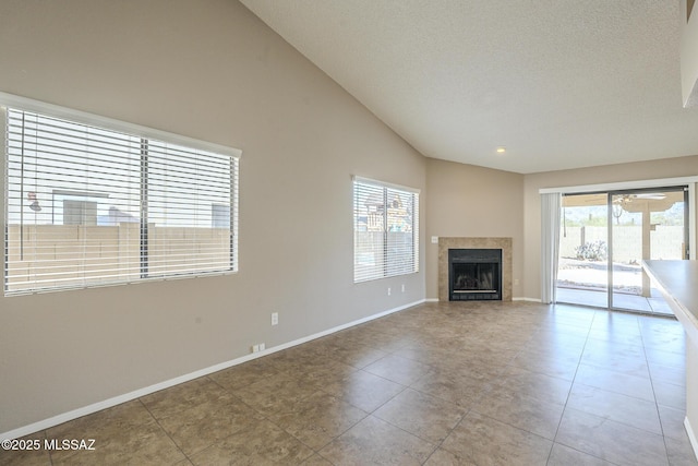 unfurnished living room featuring vaulted ceiling and light tile patterned flooring