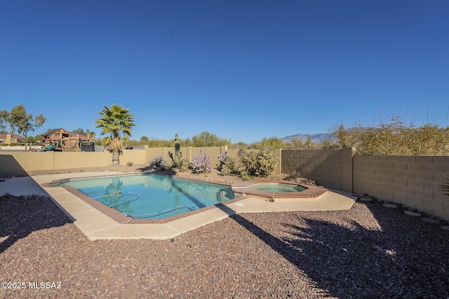 view of pool featuring an in ground hot tub