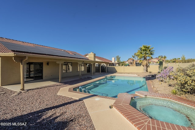 view of pool featuring a patio and an in ground hot tub