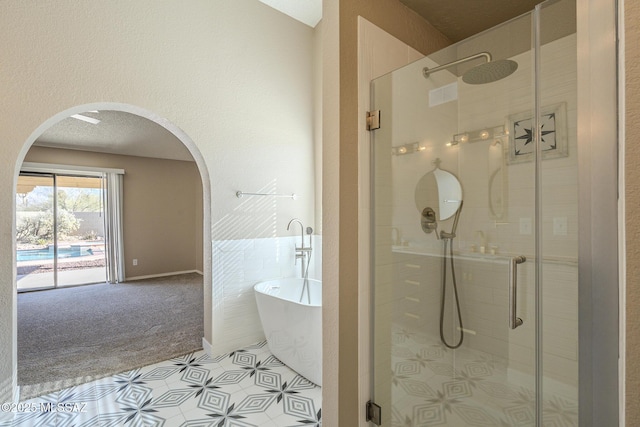 bathroom with separate shower and tub