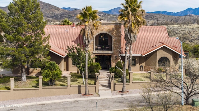 view of front of home featuring a mountain view and a balcony