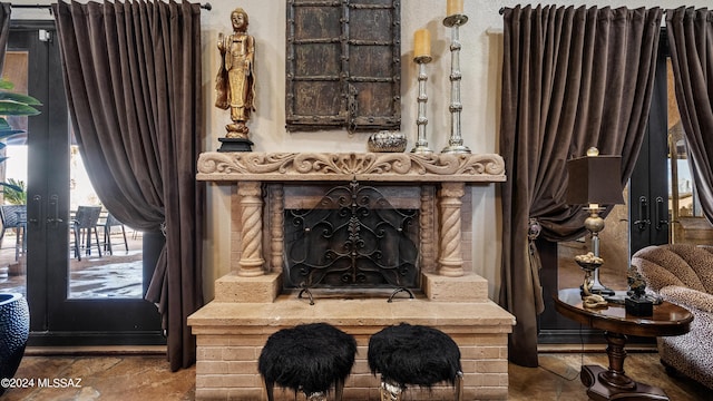 sitting room featuring a fireplace and french doors