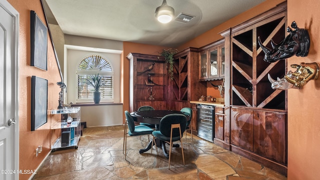 home office featuring bar, wine cooler, and ceiling fan