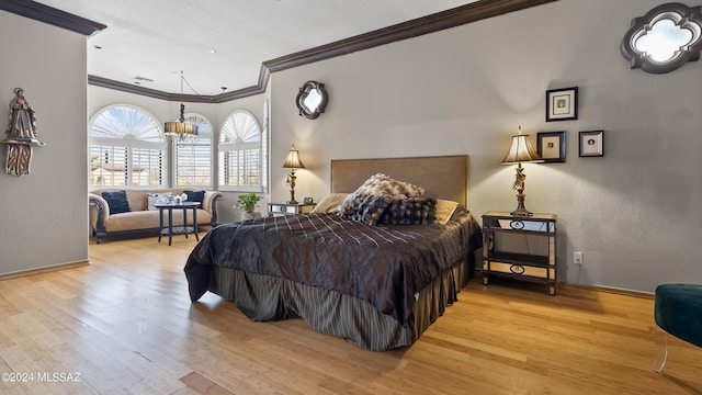 bedroom with an inviting chandelier, crown molding, and light hardwood / wood-style flooring