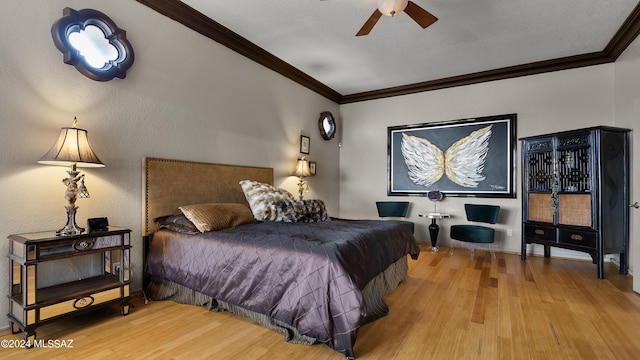 bedroom featuring ceiling fan, wood-type flooring, and ornamental molding