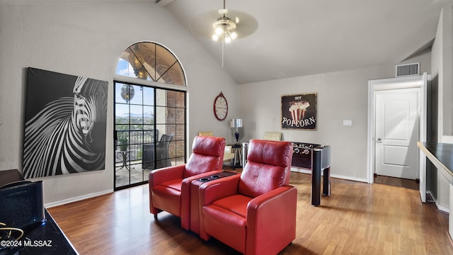 living area featuring hardwood / wood-style floors, lofted ceiling with beams, and ceiling fan