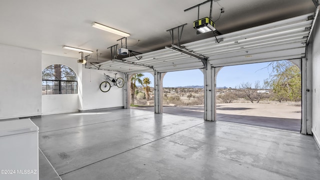 garage featuring refrigerator and a garage door opener