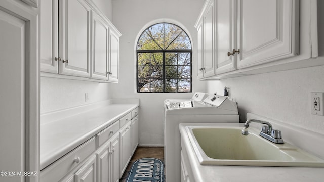 laundry room featuring cabinets, washing machine and dryer, and sink