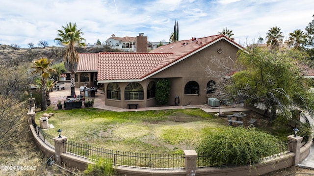 rear view of property with a lawn and central AC