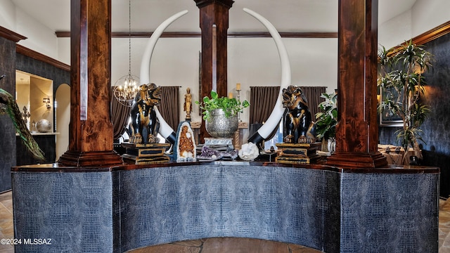 interior details featuring a chandelier and ornate columns