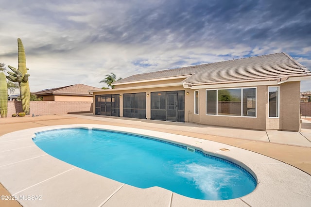 view of pool with a patio area and a sunroom