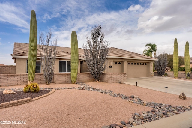 1563 N Rush Creek Ct, Green Valley, AZ 85614 - ranch-style house featuring a garage, driveway, a tile roof, and stucco siding