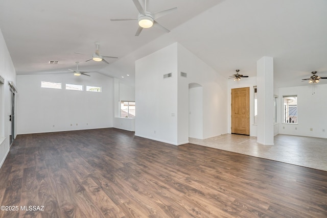 unfurnished living room with high vaulted ceiling and hardwood / wood-style floors