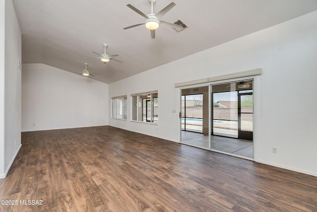 spare room featuring lofted ceiling and dark hardwood / wood-style flooring