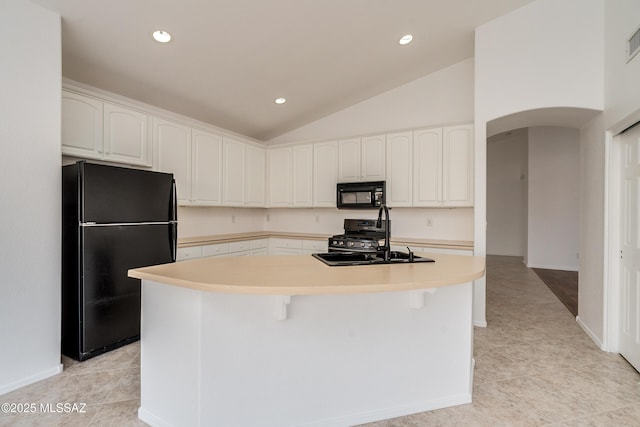 kitchen featuring sink, white cabinets, light tile patterned floors, black appliances, and a kitchen island with sink