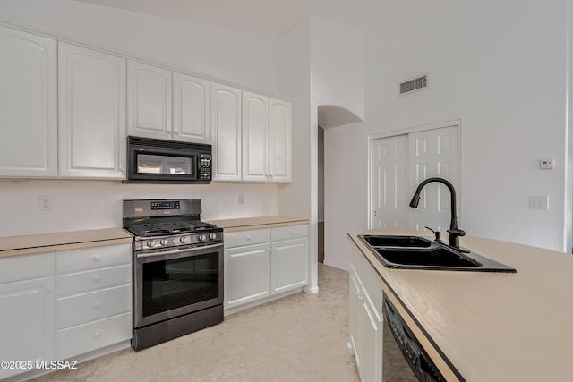 kitchen with sink, white cabinets, and black appliances