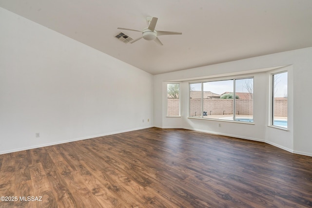 spare room featuring lofted ceiling, ceiling fan, and dark wood-type flooring