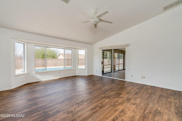 empty room featuring lofted ceiling, ceiling fan, and dark wood-type flooring