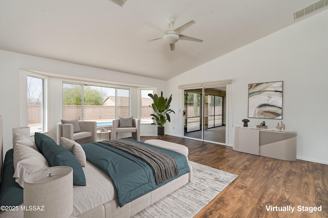 bedroom with ceiling fan, dark wood-type flooring, access to outside, and vaulted ceiling