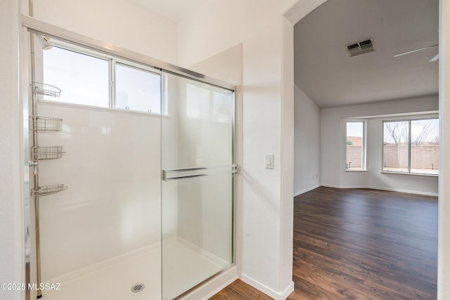 bathroom with wood-type flooring and a shower with door