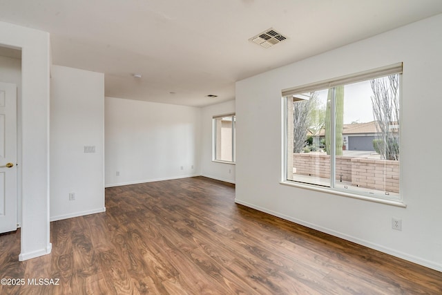 unfurnished room featuring dark wood-type flooring