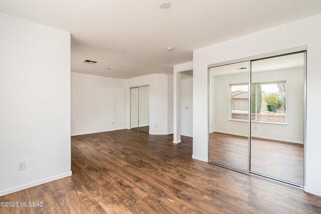 empty room featuring dark wood-type flooring