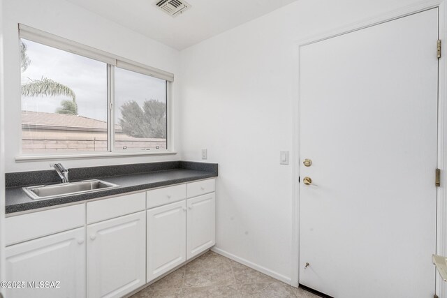 garage featuring ceiling fan, white fridge, and a garage door opener