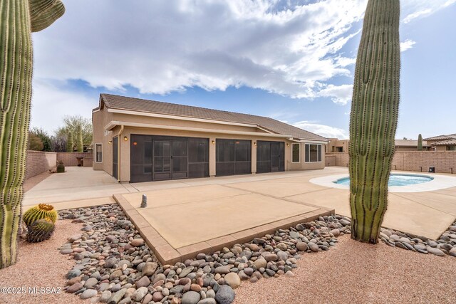 view of patio / terrace featuring an in ground hot tub