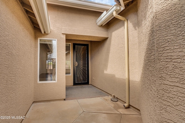 doorway to property featuring a patio area