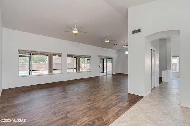 spare room with hardwood / wood-style flooring and high vaulted ceiling