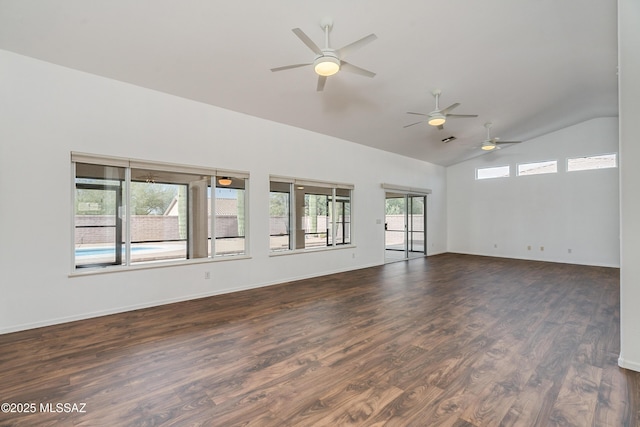 spare room featuring lofted ceiling and dark hardwood / wood-style floors