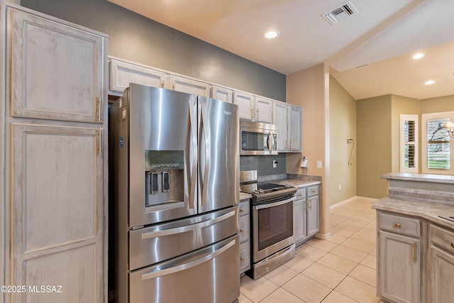 kitchen featuring appliances with stainless steel finishes, light brown cabinetry, and light tile patterned floors