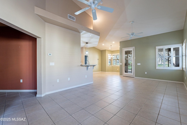 unfurnished living room with ceiling fan with notable chandelier, vaulted ceiling, and light tile patterned floors