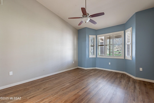 spare room featuring vaulted ceiling, hardwood / wood-style floors, and ceiling fan