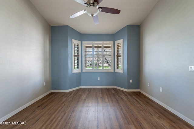 spare room with ceiling fan and dark hardwood / wood-style flooring