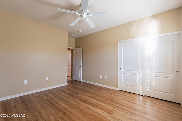 unfurnished bedroom with ceiling fan and light hardwood / wood-style floors