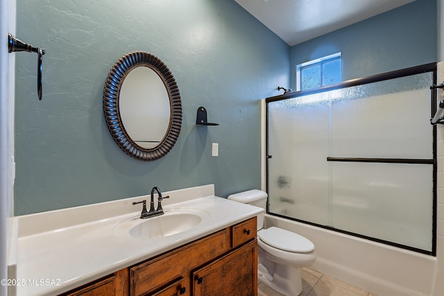 full bathroom featuring toilet, vanity, tile patterned floors, and enclosed tub / shower combo