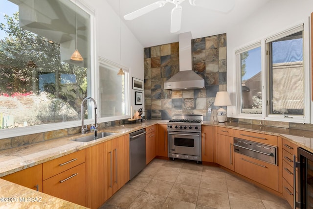 kitchen with stainless steel appliances, decorative light fixtures, beverage cooler, wall chimney exhaust hood, and sink