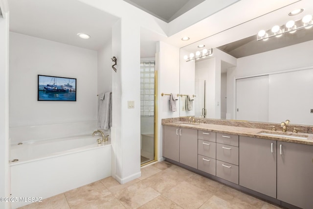 bathroom with vanity and shower with separate bathtub