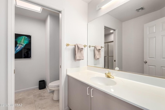 bathroom with toilet, tile patterned flooring, and vanity